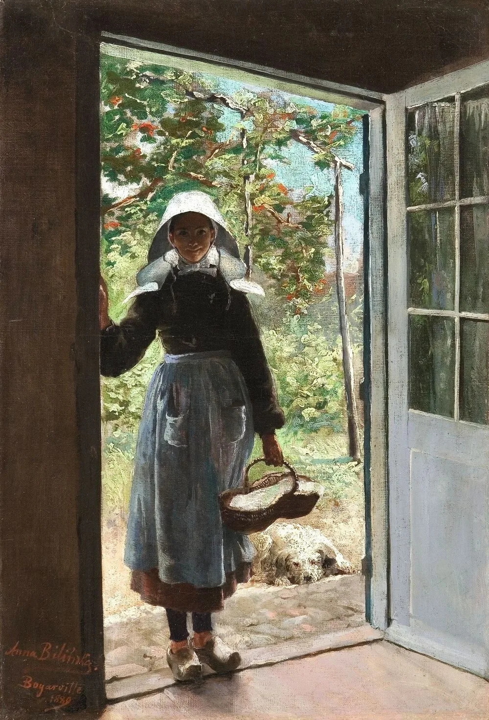 Breton woman standing on a doorstep.